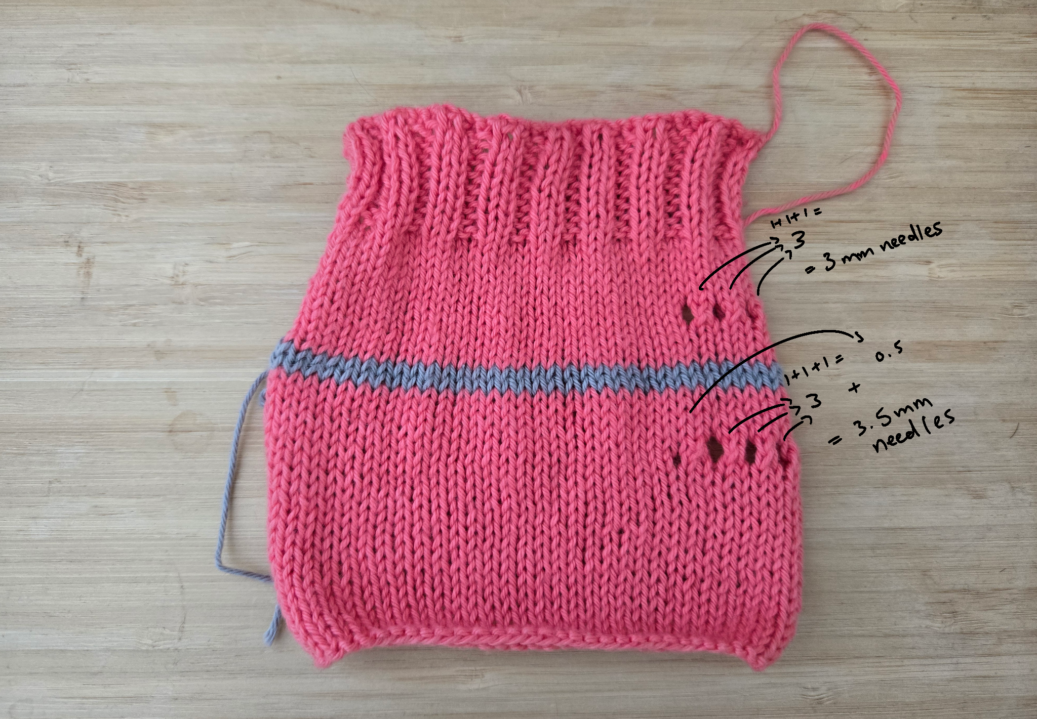a test square of knitting in bright pink