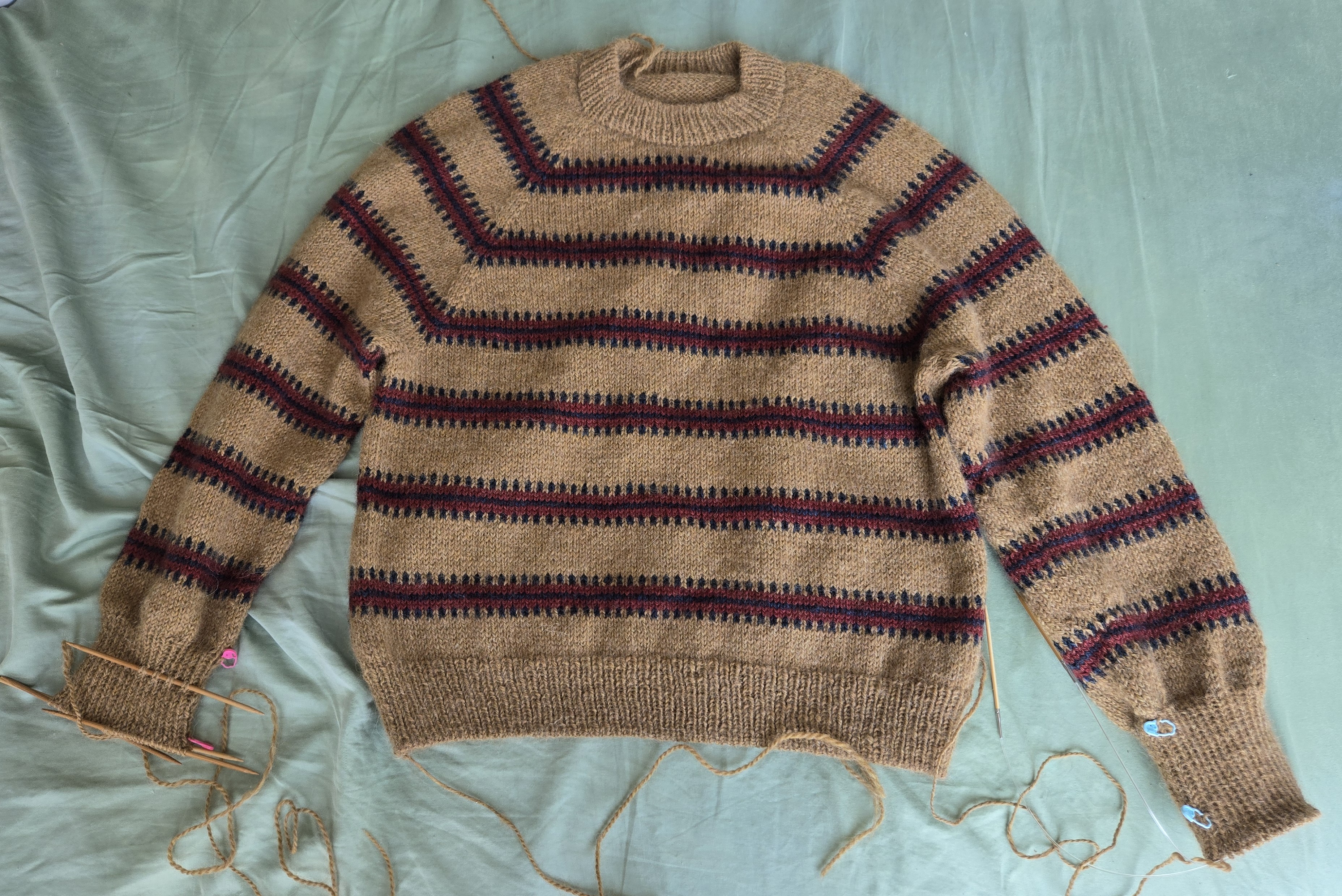 The sweater with only a few rows left on the sleeve